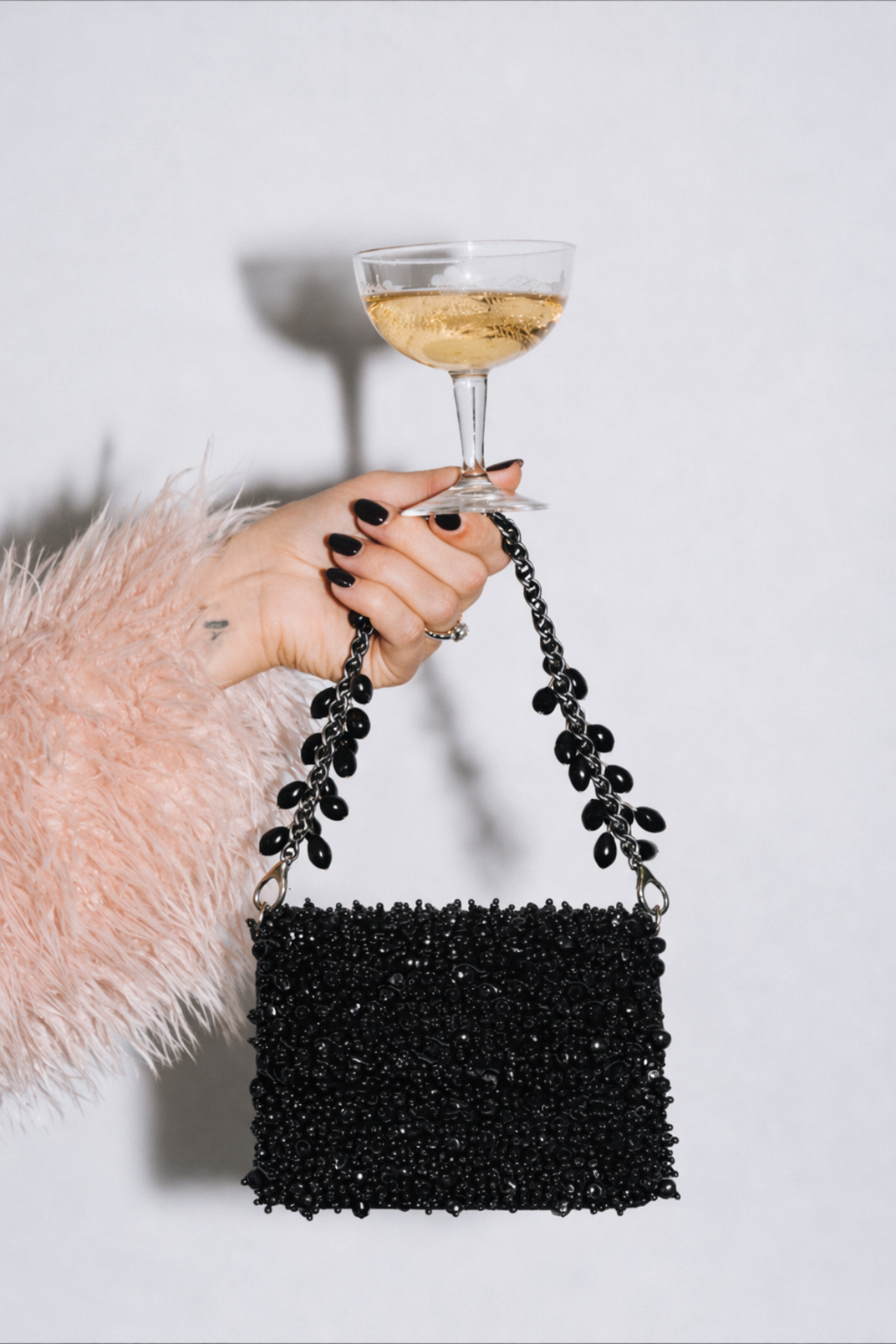 Black shoulder handbag inspired by glamorous festive dressing