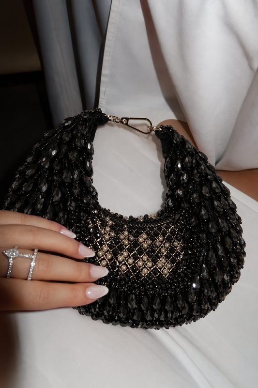 Black festive shoulder handbag inspired by glamorous celebrations and cocktail styling