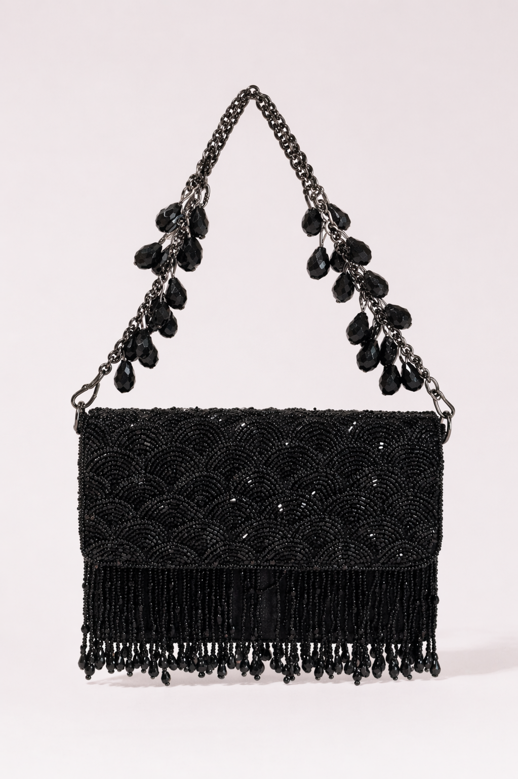 Black fringe evening handbag with intricate bead embroidery and statement chain detailing