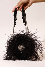 Statement black purse featuring voluminous feathers and handcrafted detailing