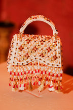Bridal trousseau purse inspired by festive couture and handcrafted craftsmanship