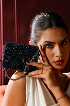 Dark blue embellished occasion bag featuring rich sparkle and handcrafted texture