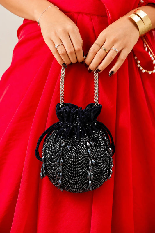 Charcoal blue festive drawstring handbag inspired by cocktail nights and celebration glamour