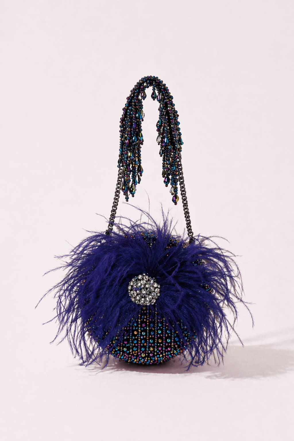 Cobalt blue feather handbag with shimmering crystal embellishments and bold texture