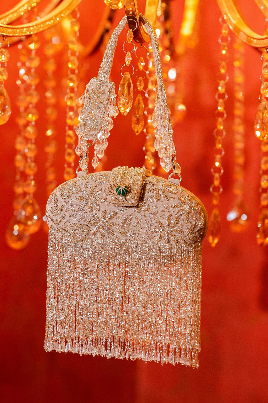 Wedding guest clutch featuring metallic fringe and reflective embellishments