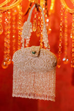 Wedding guest clutch featuring metallic fringe and reflective embellishments