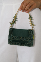 Dark green evening handbag inspired by cocktail celebrations and festive glamour
