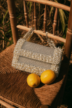 Denim pearl party bag featuring handcrafted detailing and subtle sparkling texture