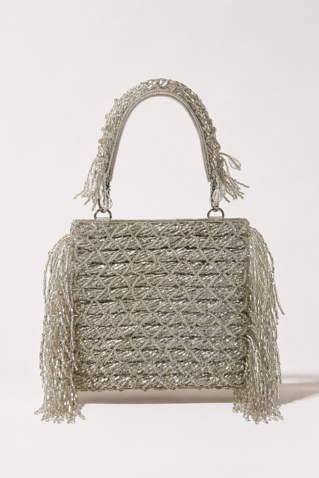 Designer silver party bag with textured embellishments and elegant fringe detailing