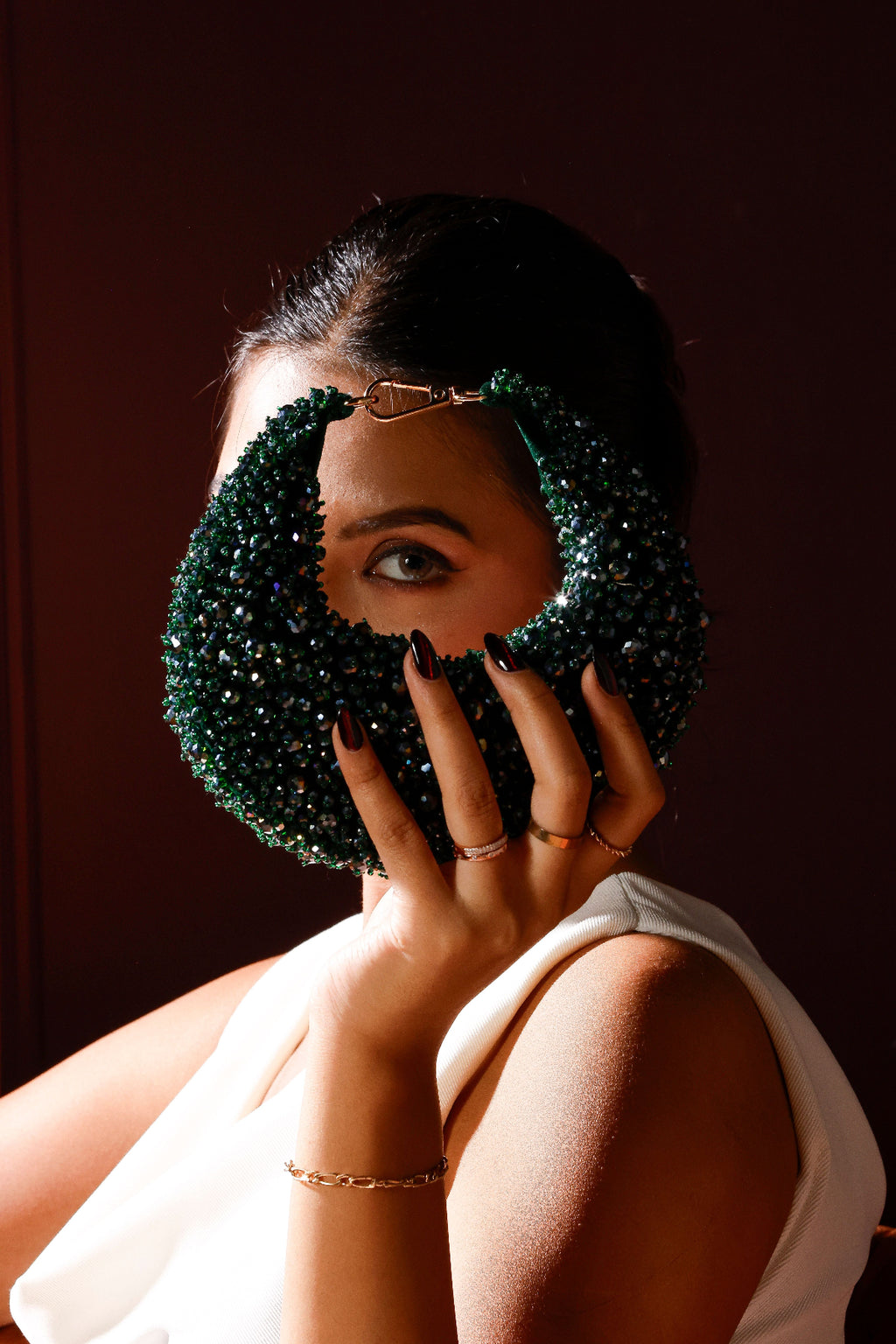 Embellished party handbag with rich jewel tones and sculptural silhouett