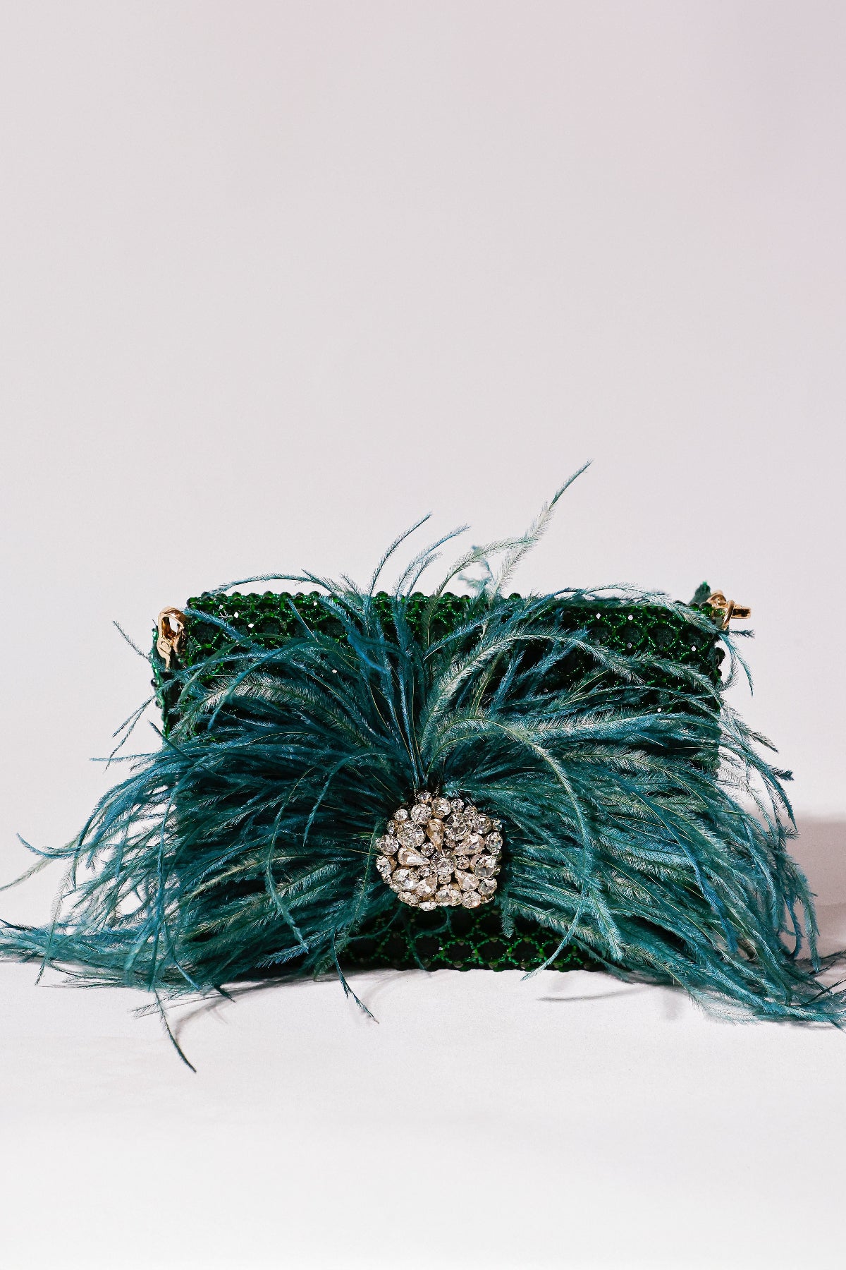 Reception evening bag with voluminous feathers and radiant crystal centerpiece detailing