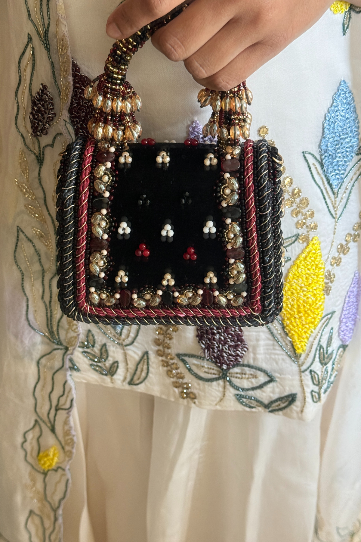 Gift-worthy black mini bag featuring rich embellishments and sophisticated festive appeal