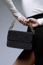Gift-worthy designer bag featuring statement embellishments and timeless festive appeal