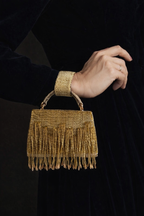 Gift-worthy gold clutch featuring elegant embellishments and timeless festive charm