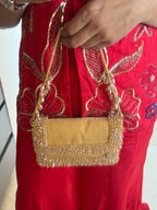 Gift-worthy gold handbag featuring luxe embellishments and timeless festive appeal