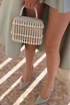 Gift-worthy pearl handbag featuring luxurious embellishments and timeless festive charm