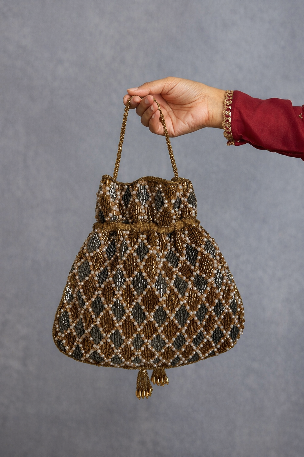 Gift-worthy wedding potli featuring elegant silver-golden detailing and festive charm