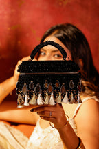 Black occasion purse with intricate tassel embellishments and artisanal craftsmanship
