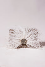 Cocktail purse combining fluffy feather texture with handcrafted embellishments