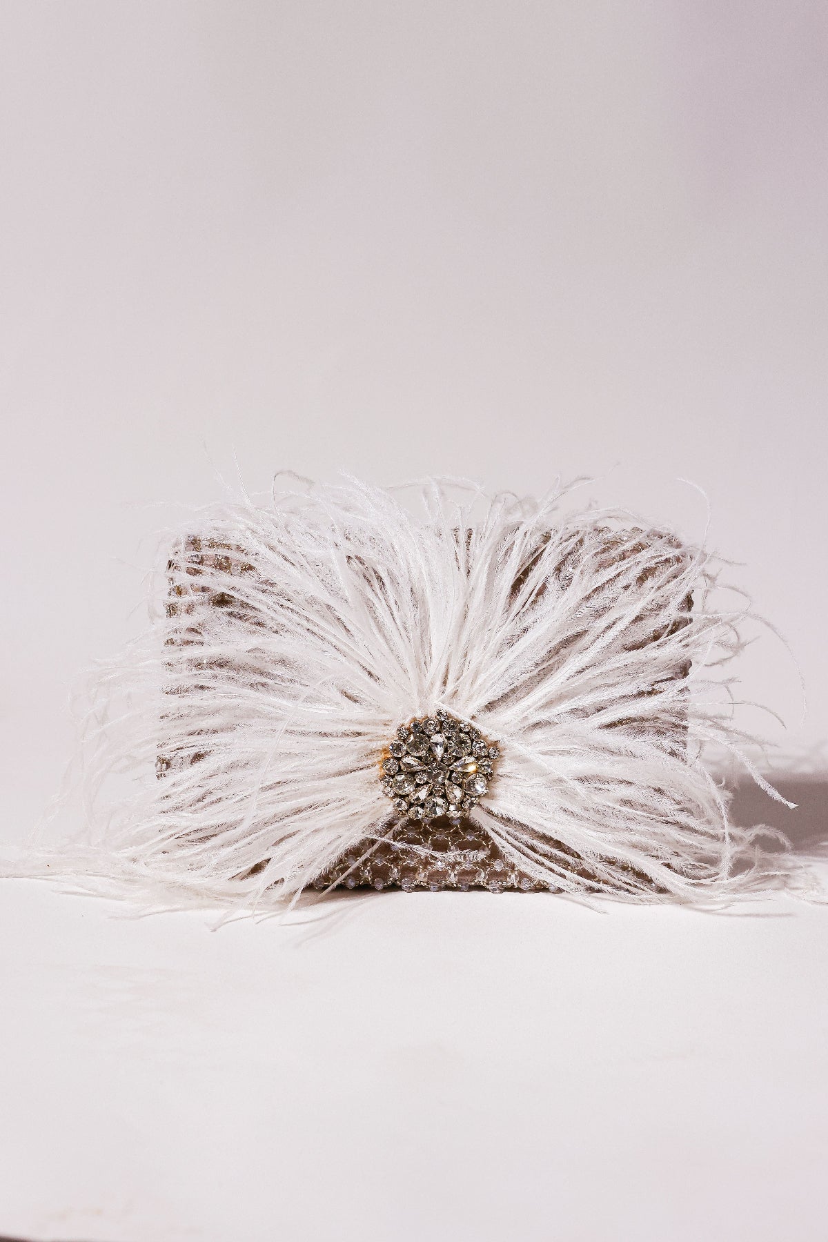 Cocktail purse combining fluffy feather texture with handcrafted embellishments