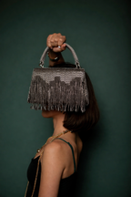 Glam mini party clutch with metallic fringe accents and modern festive appeal