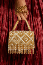 Luxury gold evening handbag featuring geometric beadwork and statement fringe accents