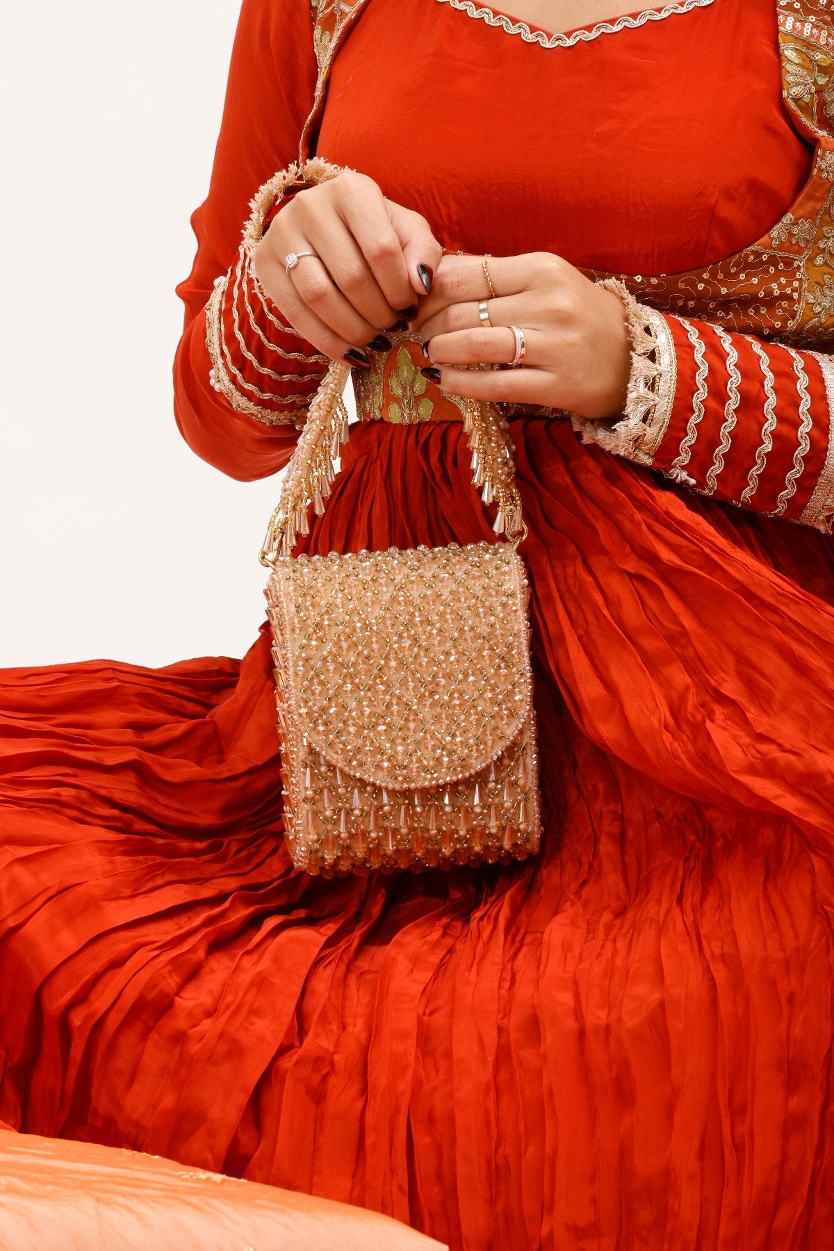 Gift-worthy occasion handbag combining artisanal craftsmanship with festive glamour