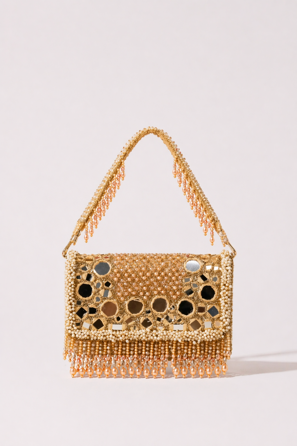Gold mirror work handbag with intricate bead detailing and festive tassel accents