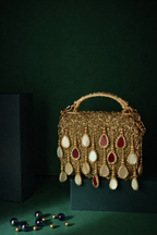 Gold stone embellished handbag featuring reflective mirror accents and elegant tassels