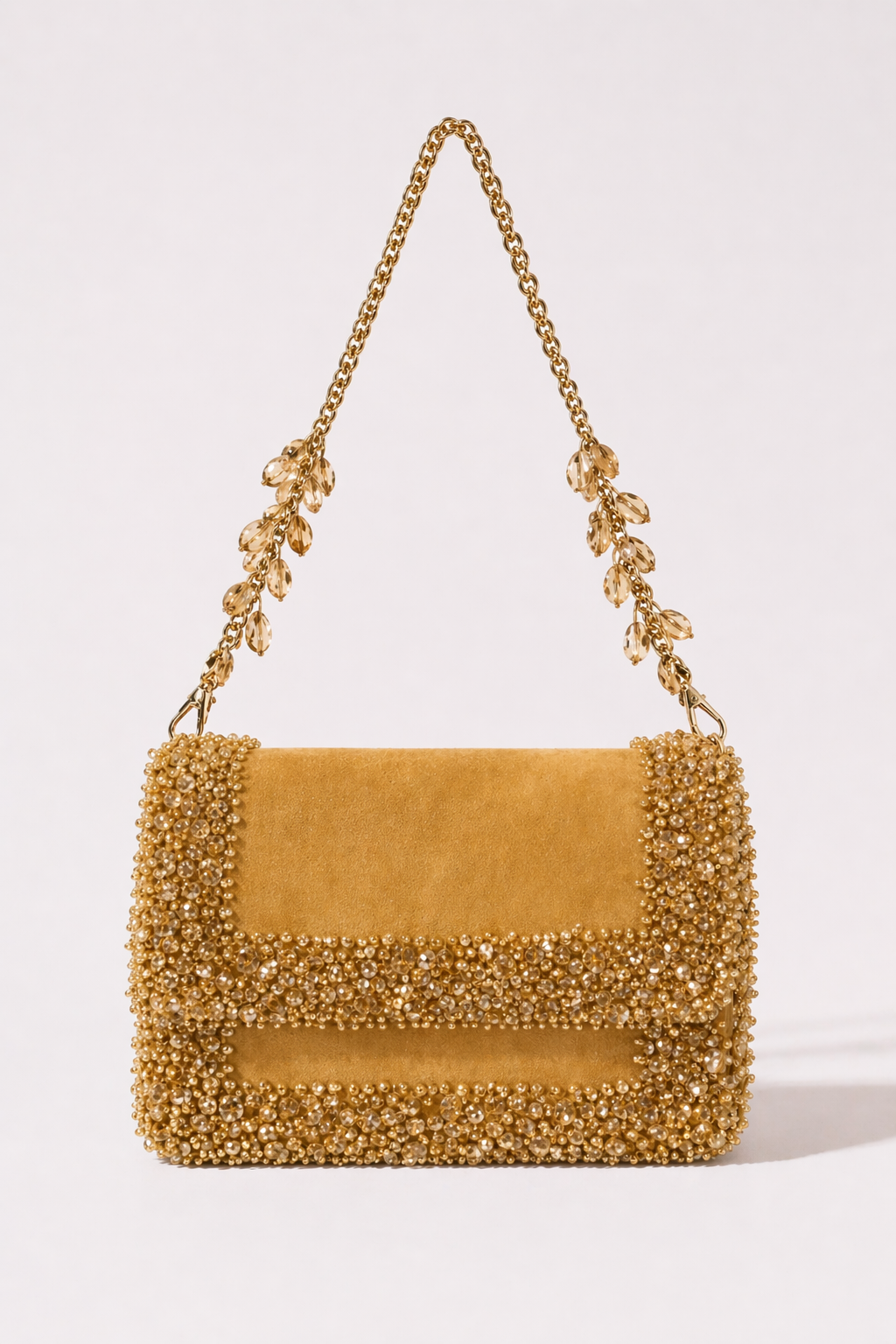 Gold suede shoulder bag with sparkling crystal embellishments and elegant chain detailing