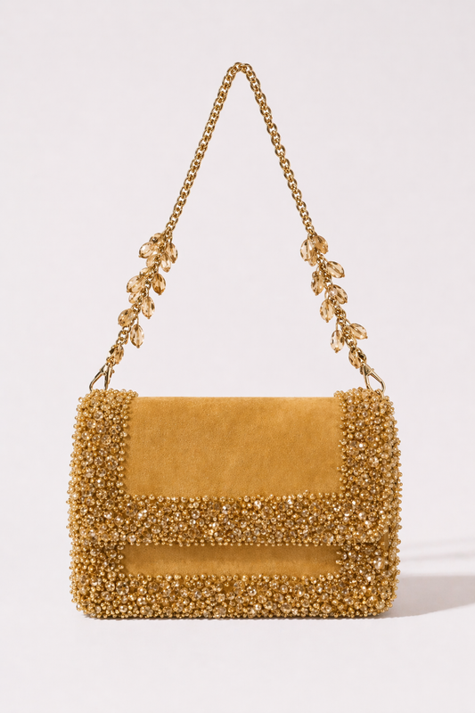 Gold suede shoulder bag with sparkling crystal embellishments and elegant chain detailing