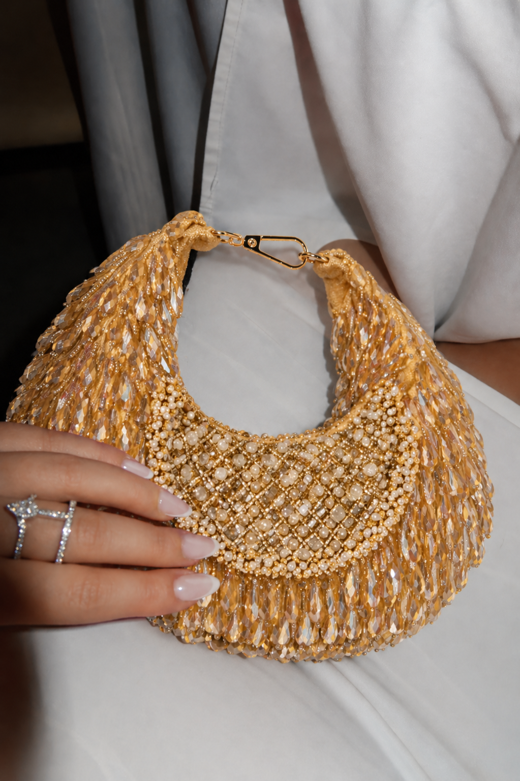 Golden festive shoulder handbag inspired by glamorous celebrations and cocktail styling