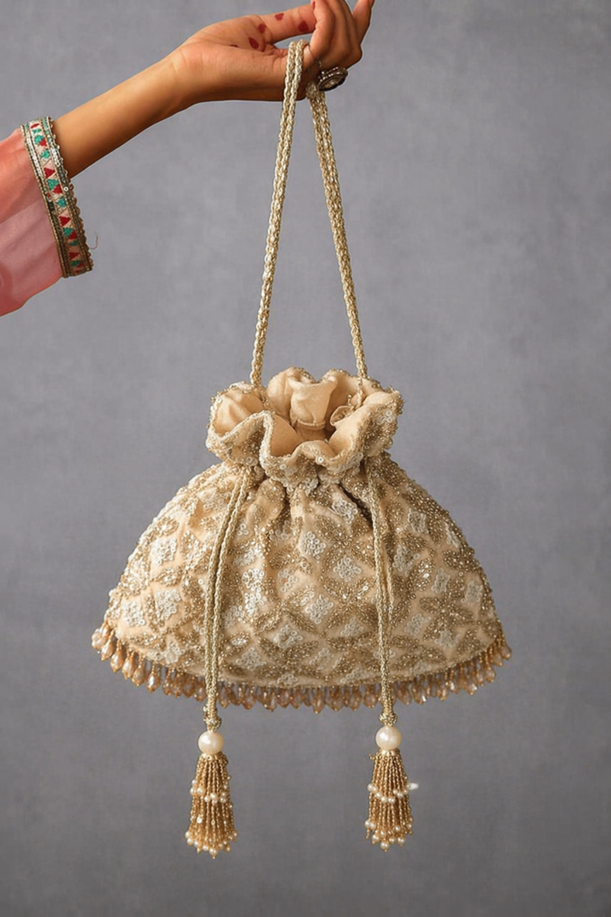 Golden traditional drawstring handbag inspired by wedding celebrations and ethnic glamour