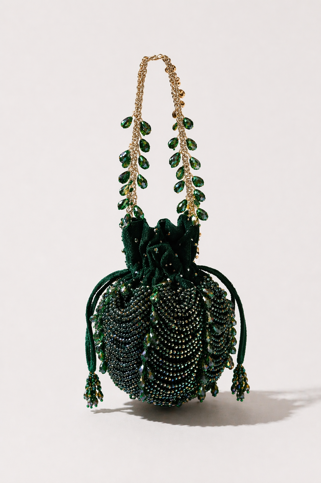 Green beaded potli bag with layered embellishments and elegant festive detailing