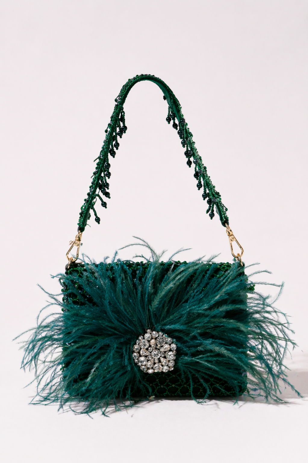 Green feather handbag with sparkling crystal embellishments and bold couture-inspired texture