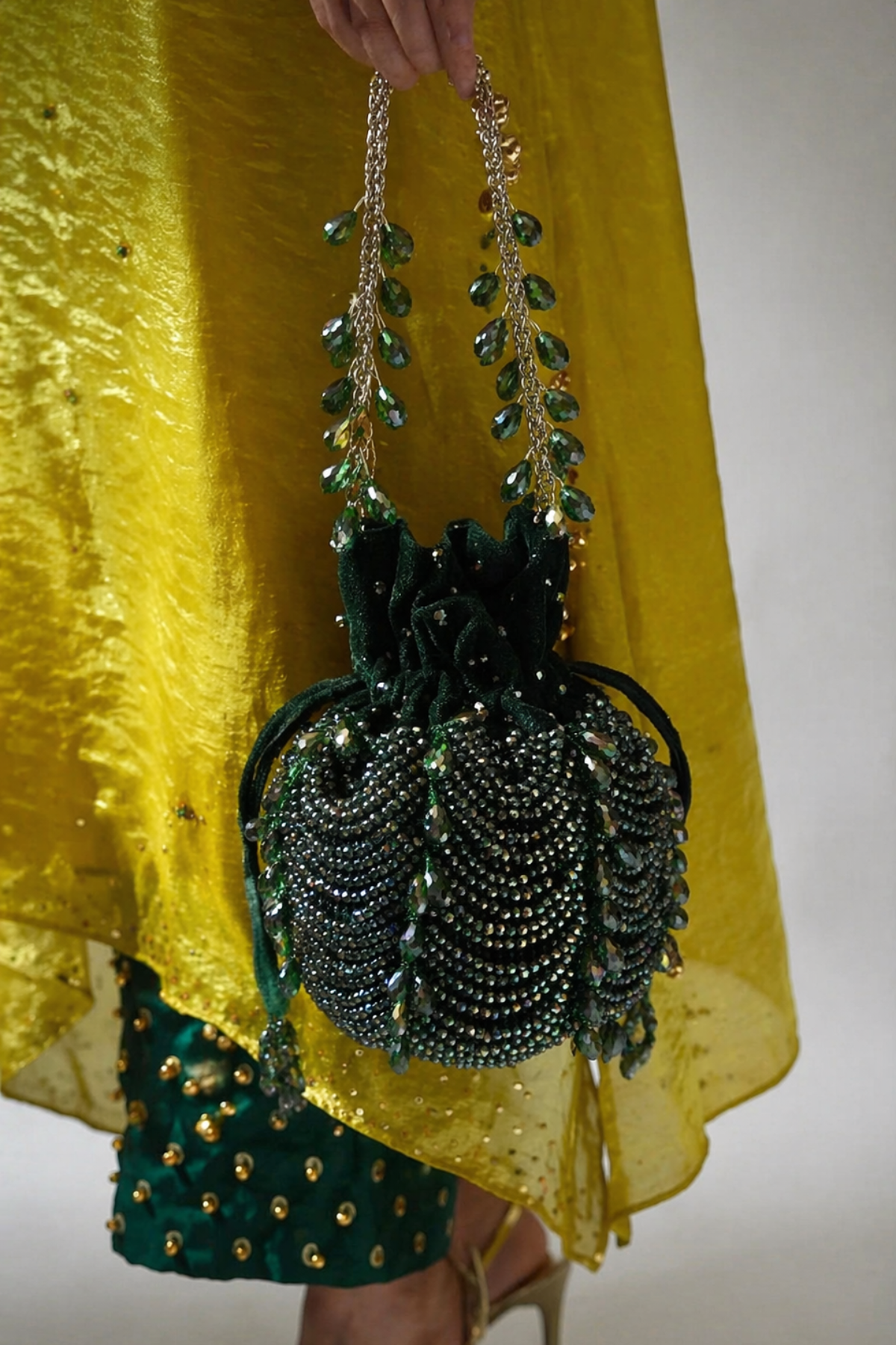 Green festive drawstring handbag inspired by wedding celebrations and ethnic glamour