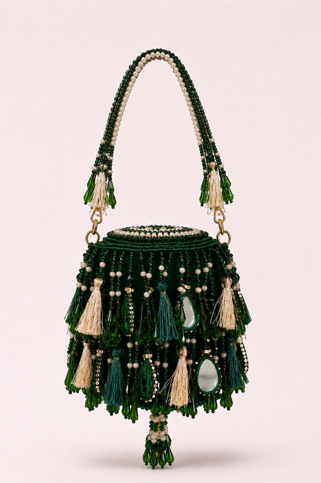Green mirror work mini bag with elegant tassel detailing and handcrafted festive texture
