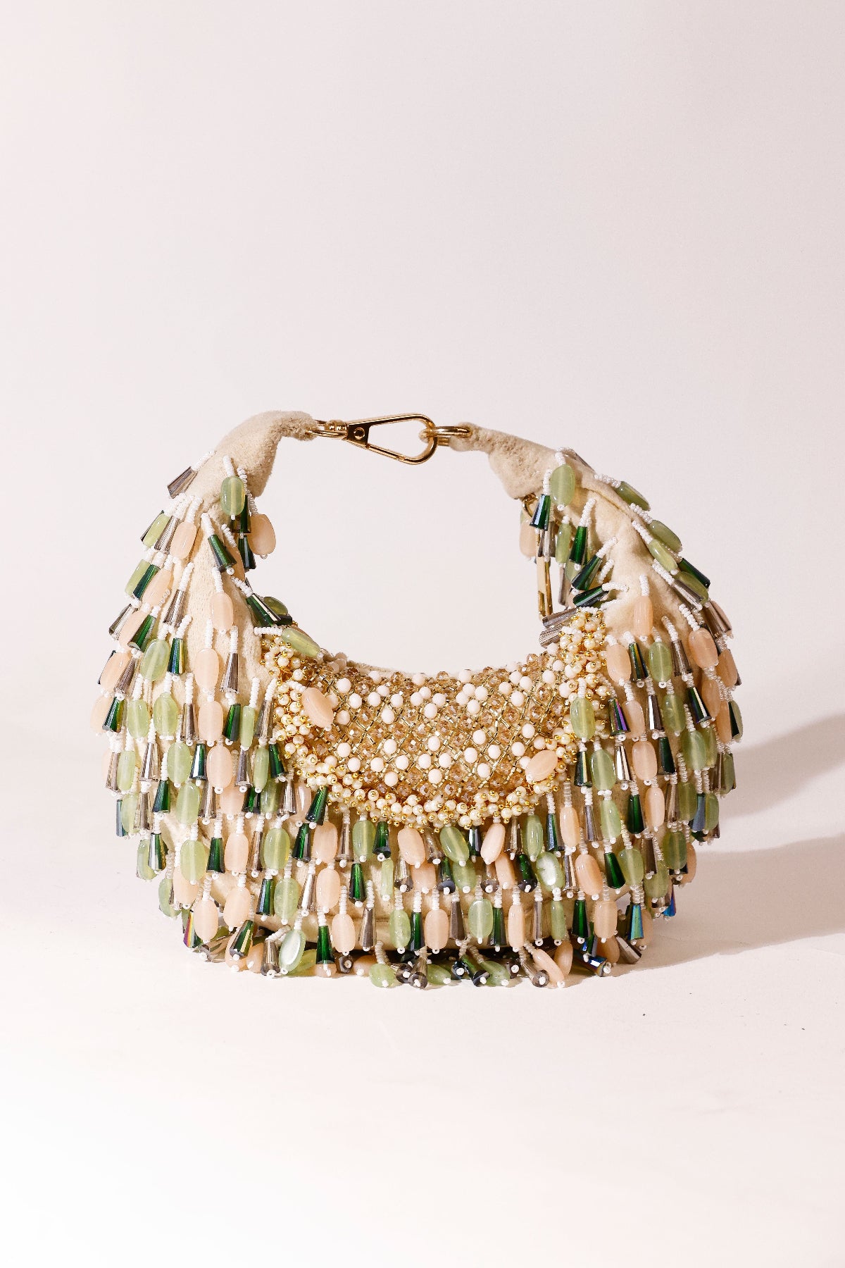 Sculptural hobo accessory combining earthy tones with shimmering embellishments