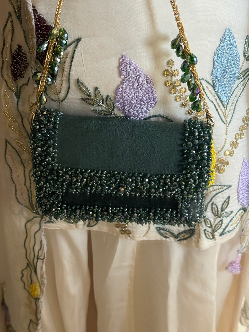 Green stone embellished bag designed beautifully for receptions and occasion dressing