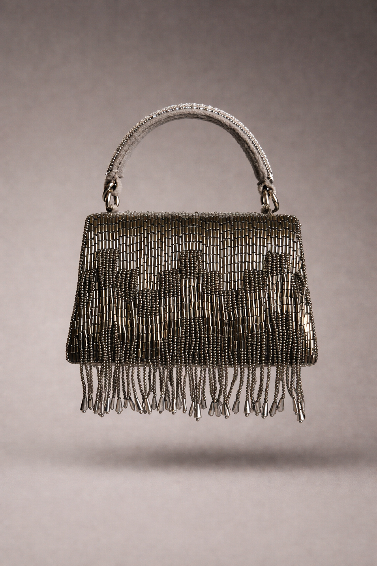 Gunmetal fringe evening purse featuring statement embellishments and sophisticated sparkle
