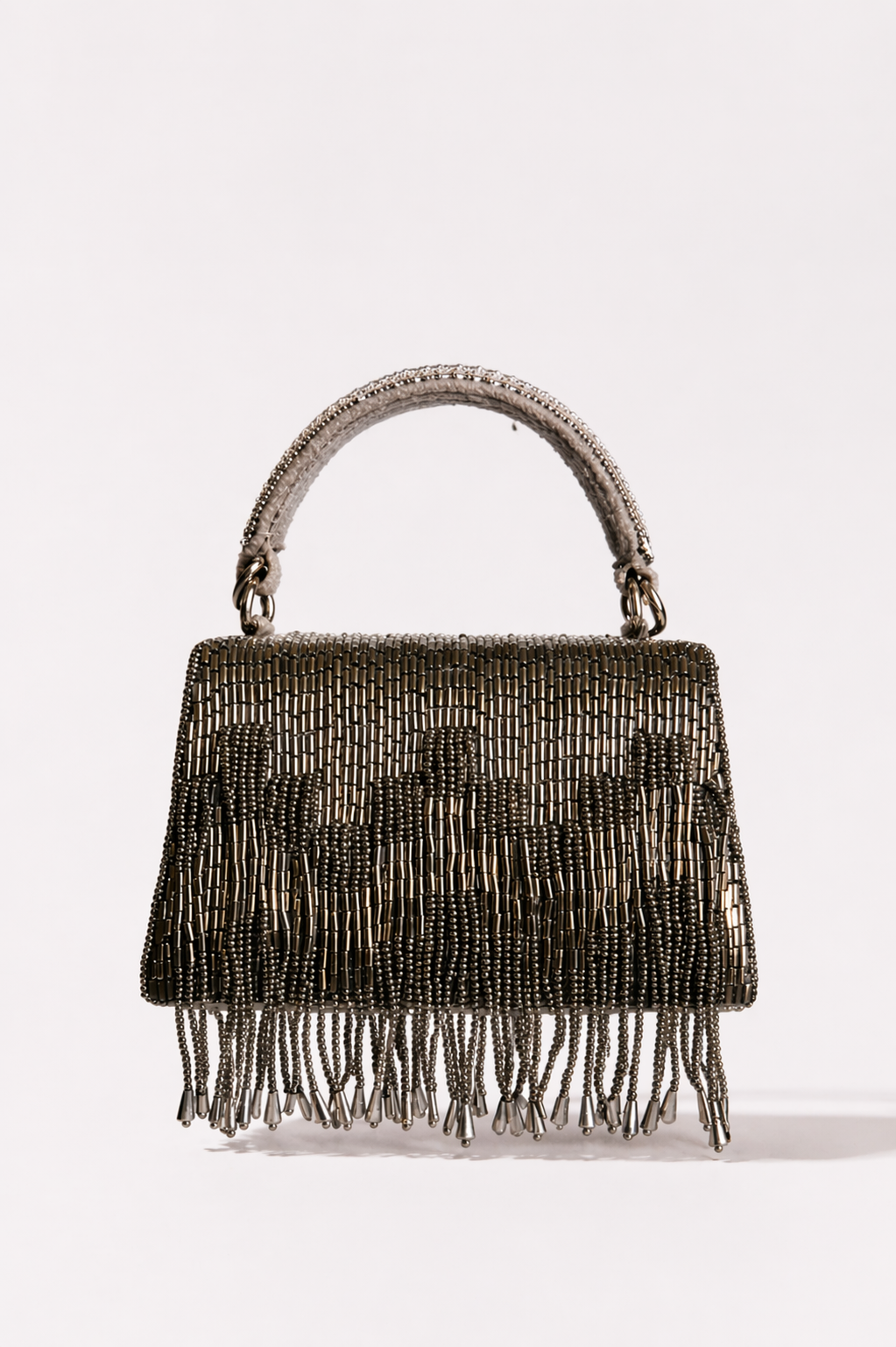 Gunmetal trousseau clutch with shimmering fringe detailing and elegant handcrafted texture