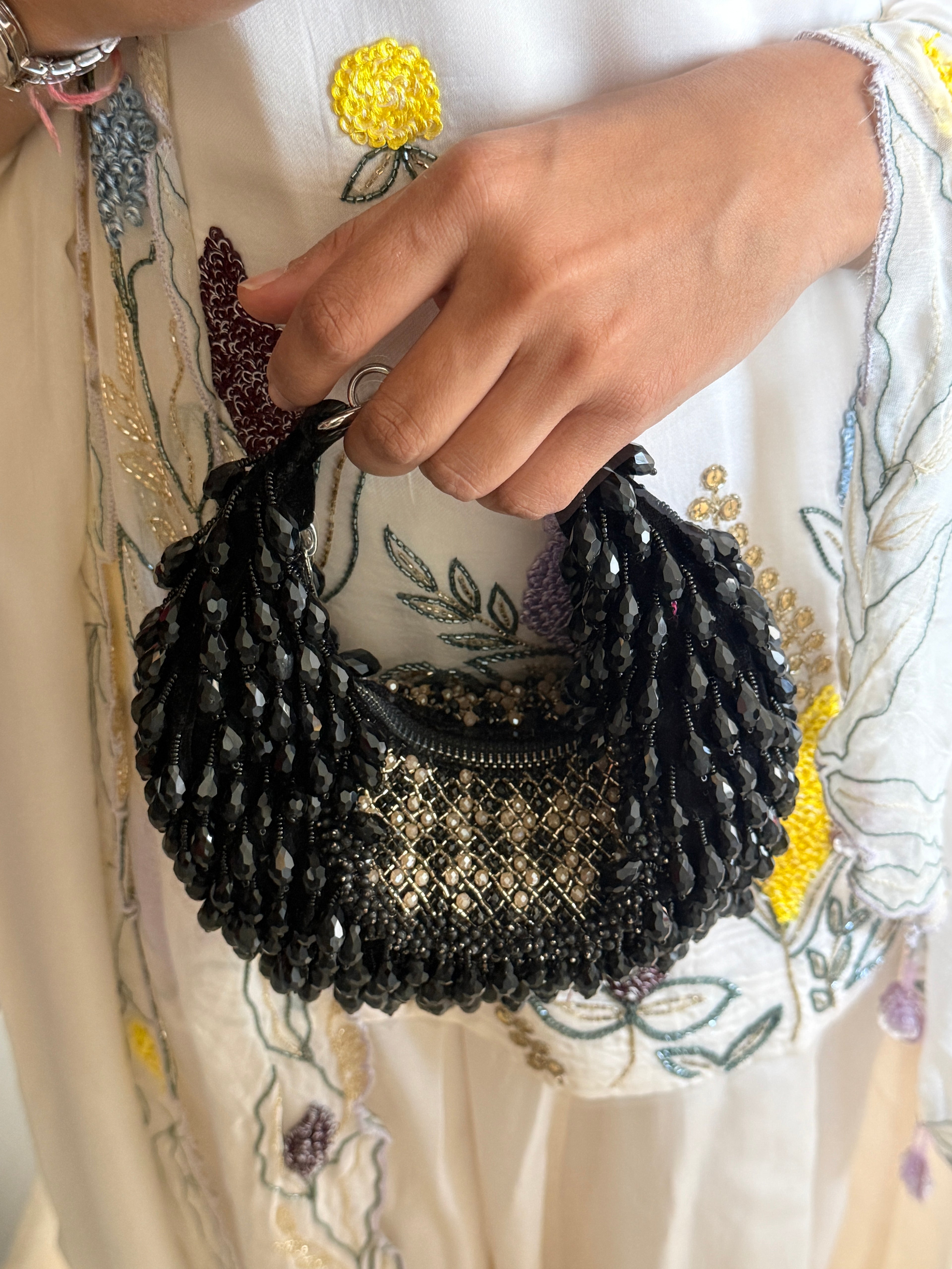 Handcrafted black celebration purse with layered embellishments and elegant sparkle