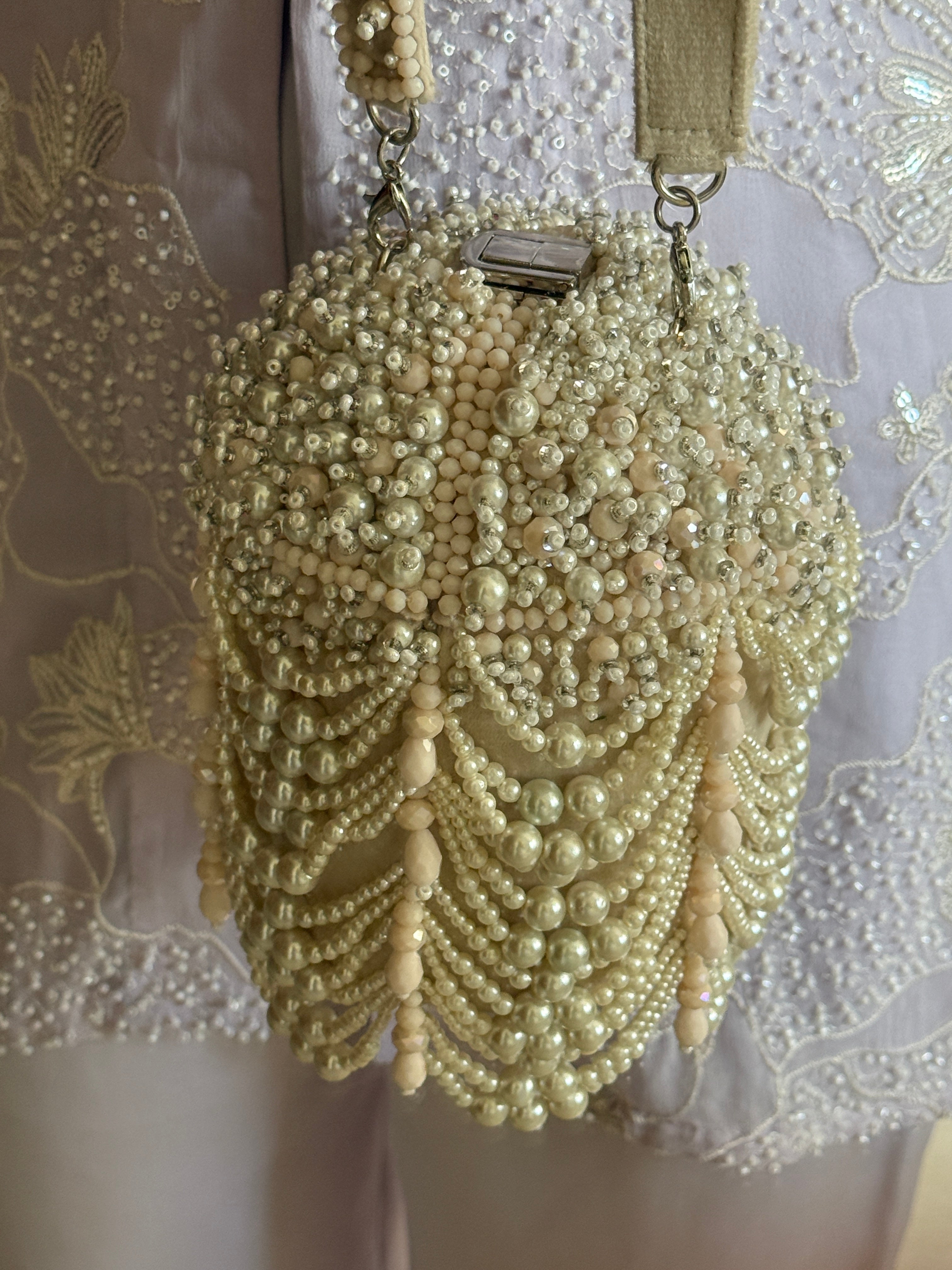 Handcrafted festive bucket purse combining pearl embellishments with couture-inspired glamour