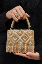 Handcrafted gold statement handbag combining artisanal craftsmanship with festive glamour