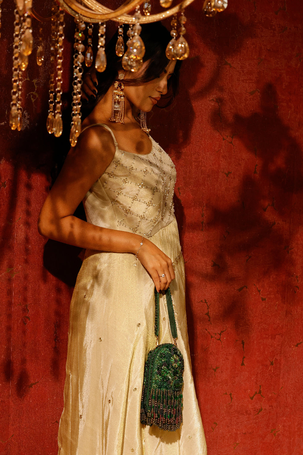 Statement emerald occasion bag featuring textured beadwork and cascading fringe accents