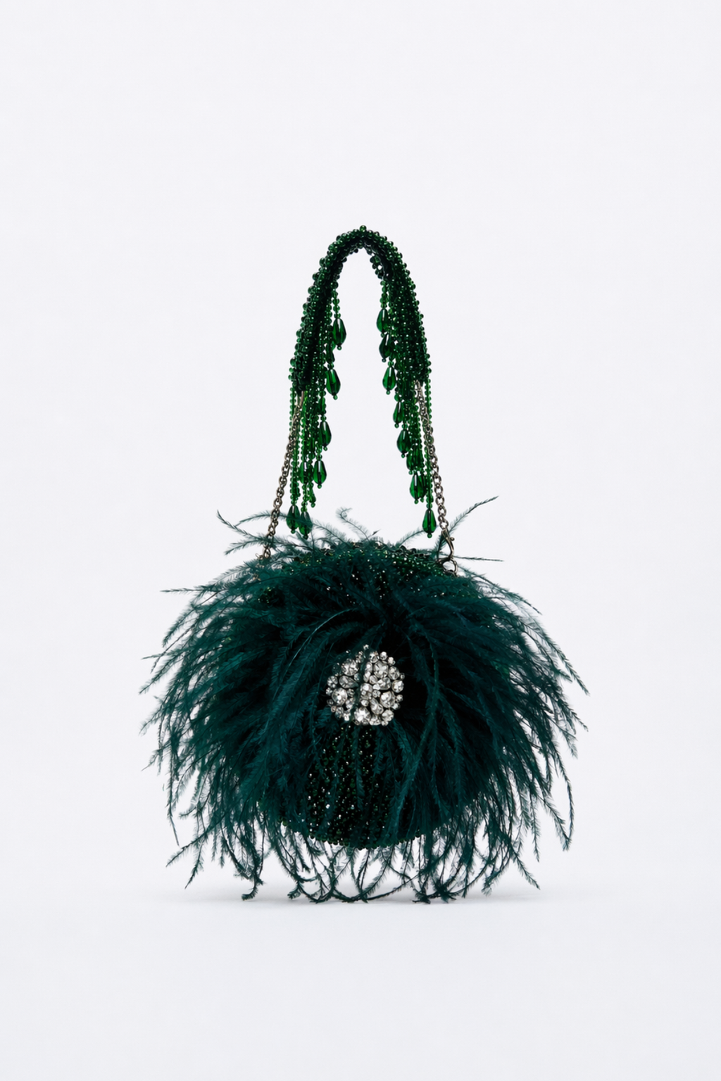 Handcrafted green evening purse combining couture-inspired feathers with luxe sparkle