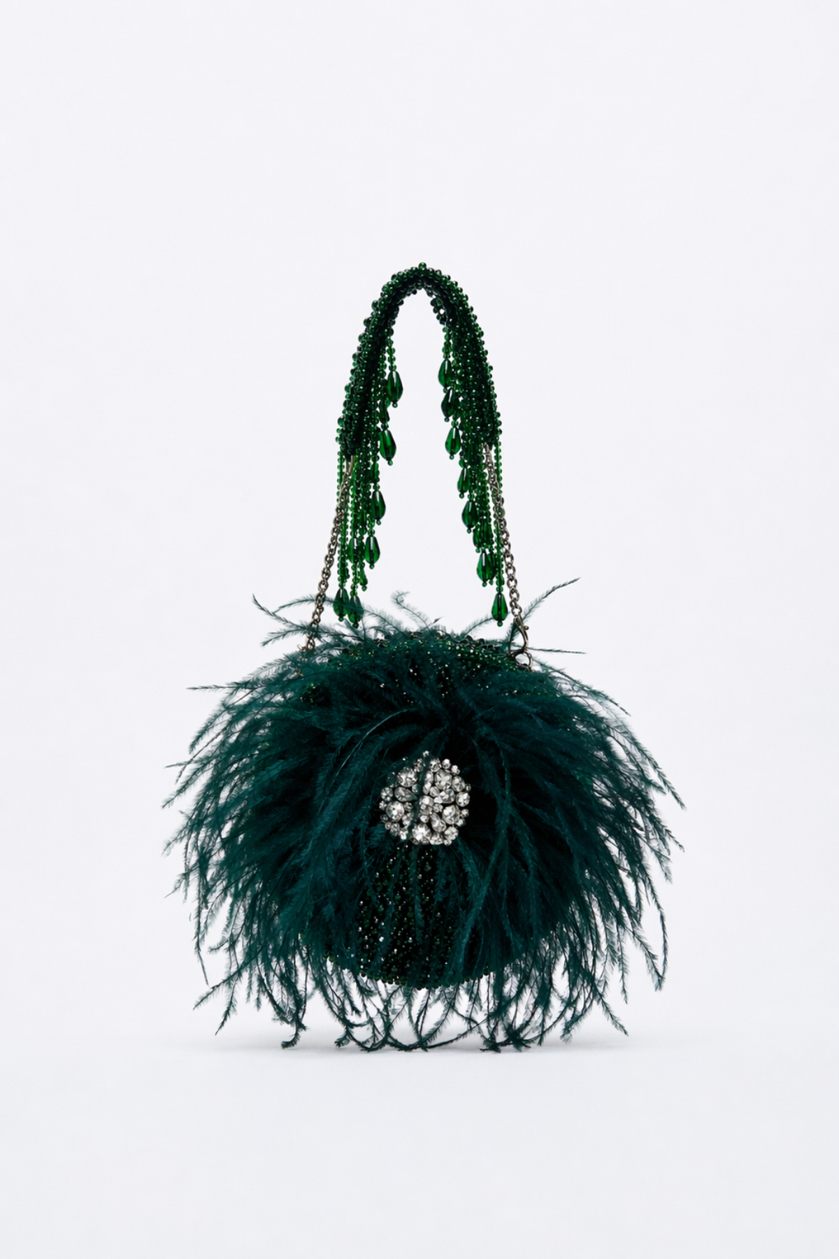 Handcrafted green evening purse combining couture-inspired feathers with luxe sparkle