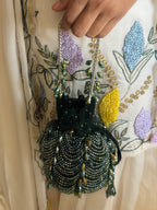 Handcrafted green party purse combining rich texture with celebration-ready glamour