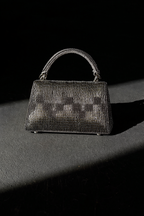 Handcrafted gunmetal sling bag combining artisanal craftsmanship with elegant party glamour