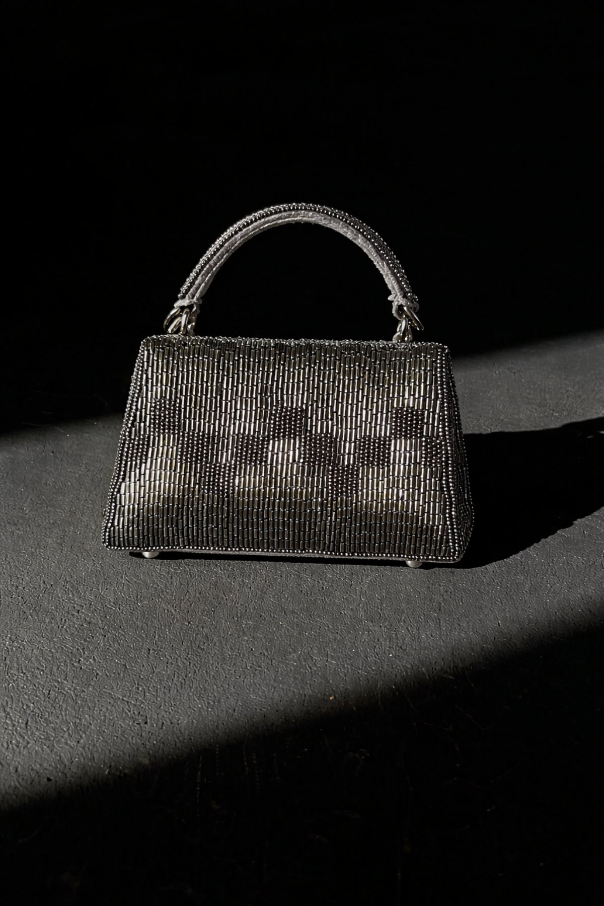 Handcrafted gunmetal sling bag combining artisanal craftsmanship with elegant party glamour